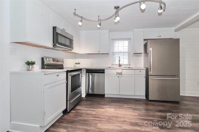 kitchen with white cabinetry, stainless steel appliances, and sink