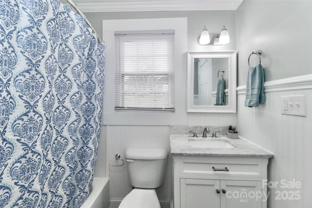 bathroom featuring vanity, ornamental molding, and toilet