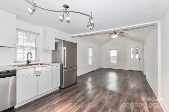 kitchen with white cabinetry, lofted ceiling, stainless steel appliances, and sink