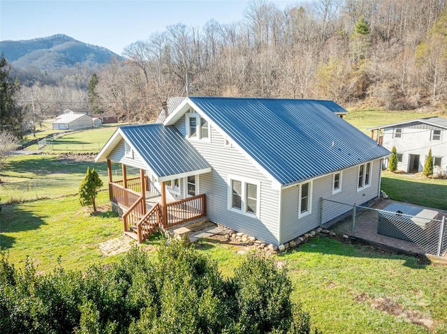 exterior space with a mountain view, a yard, and covered porch