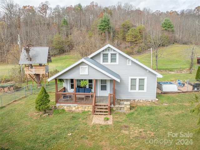 rear view of property featuring a lawn