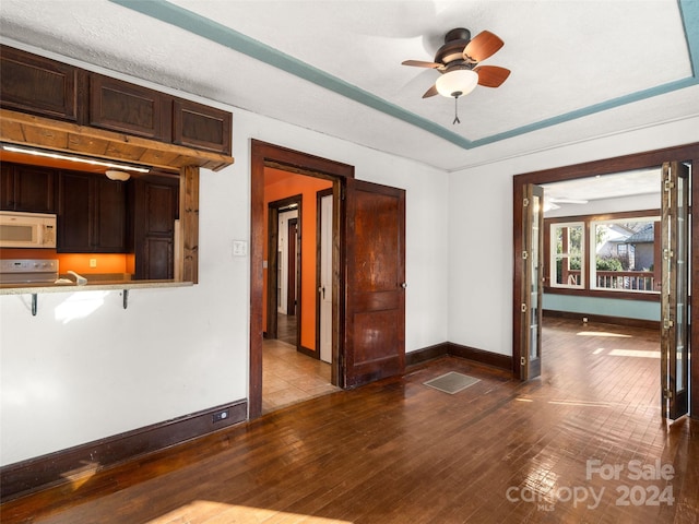 interior space with ceiling fan and wood-type flooring