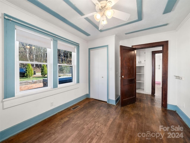 unfurnished bedroom featuring ceiling fan, dark hardwood / wood-style flooring, and ornamental molding