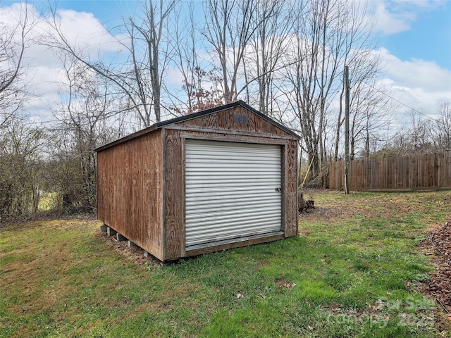 view of outdoor structure featuring a yard and a garage