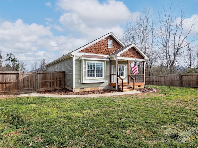 view of front of home featuring crawl space, a gate, fence, and a front lawn