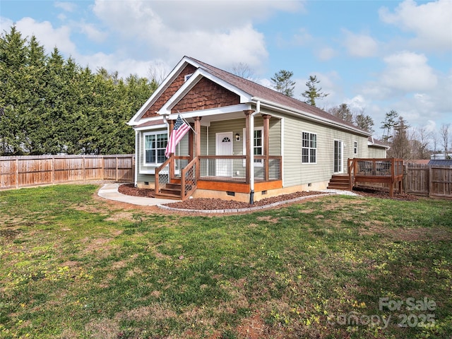 view of front of home featuring crawl space, a fenced backyard, a deck, and a front lawn