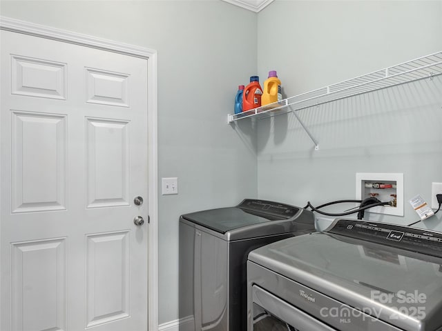 clothes washing area featuring laundry area and washing machine and clothes dryer