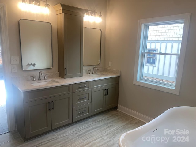 bathroom featuring a bath, hardwood / wood-style floors, and vanity