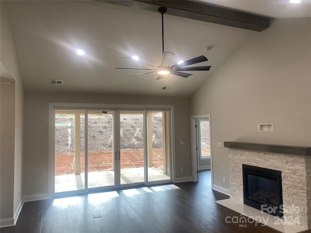 unfurnished living room featuring dark hardwood / wood-style floors, a healthy amount of sunlight, a stone fireplace, and ceiling fan