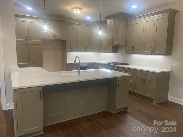 kitchen featuring light stone countertops, dark wood-type flooring, sink, gray cabinets, and hanging light fixtures