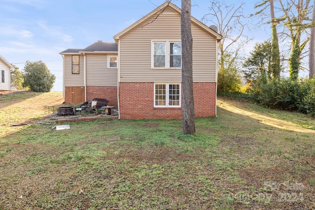 view of side of home with a yard