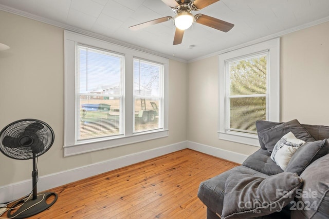 sitting room with ceiling fan, crown molding, and light hardwood / wood-style flooring