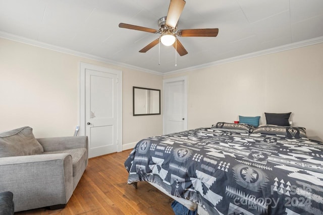 bedroom featuring ceiling fan, crown molding, and wood-type flooring