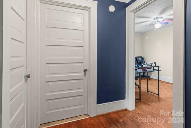 interior space featuring wood-type flooring and ornamental molding