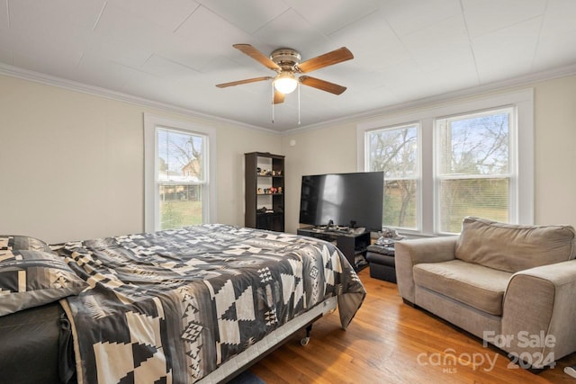 bedroom with ceiling fan, light hardwood / wood-style floors, and crown molding