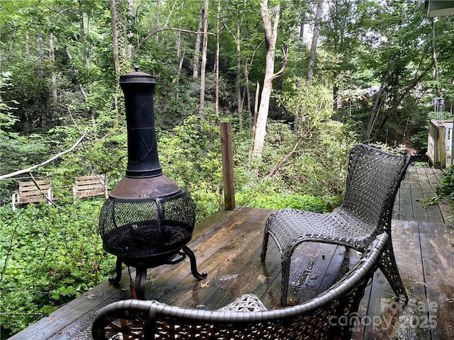 view of patio featuring an outdoor fire pit and a wooden deck