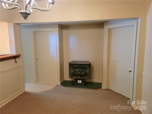 interior space with carpet flooring and a chandelier