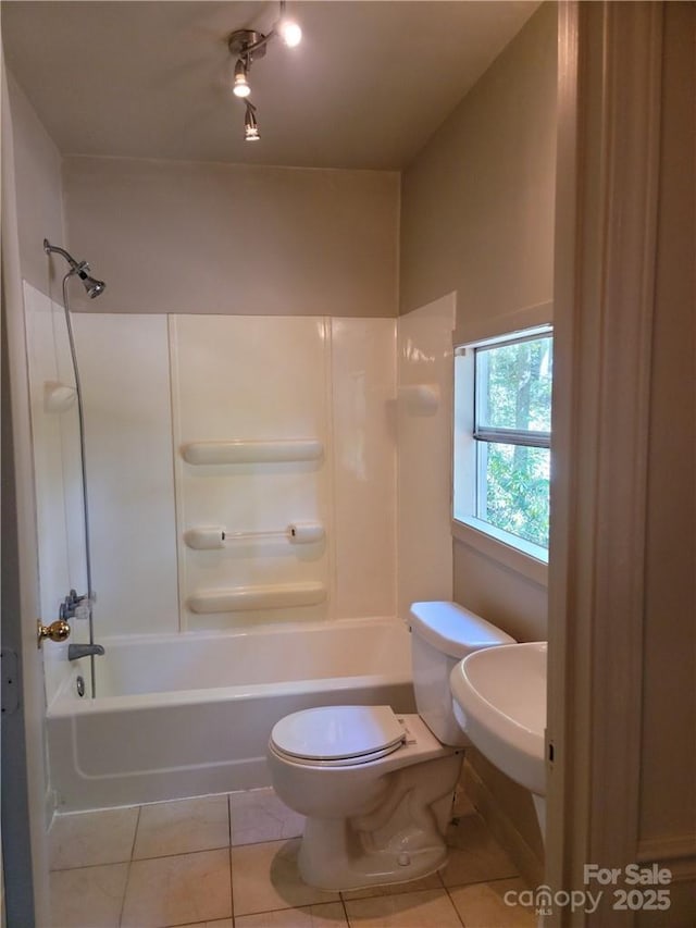 full bathroom with shower / washtub combination, sink, tile patterned flooring, and toilet