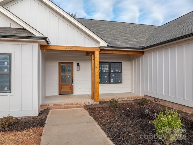 view of exterior entry with a porch