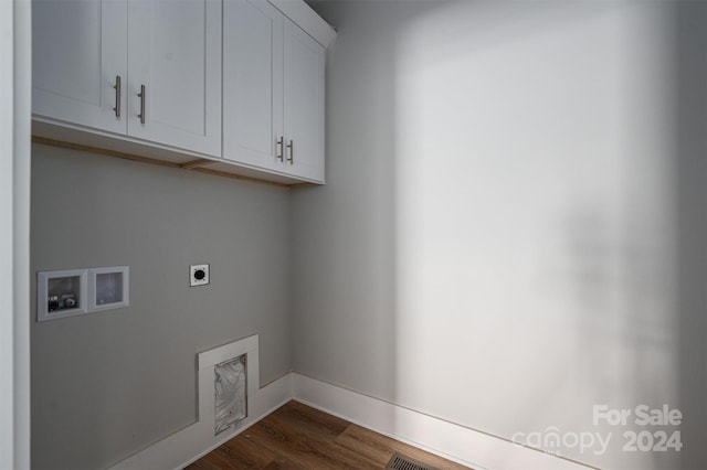 laundry room featuring electric dryer hookup, cabinets, dark hardwood / wood-style floors, and washer hookup