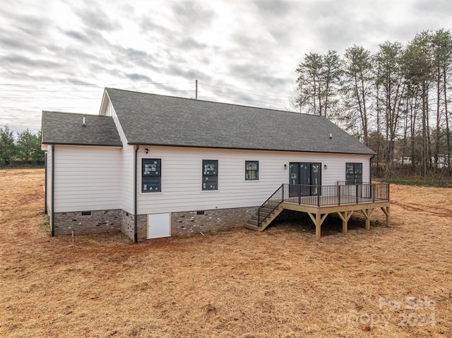 rear view of property featuring a deck