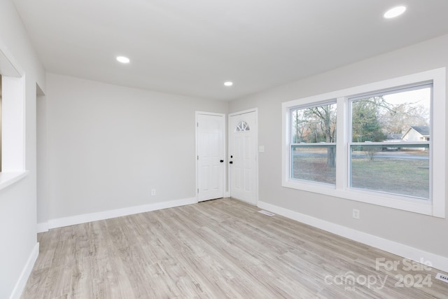 empty room with light hardwood / wood-style flooring