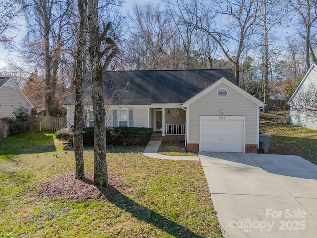 single story home with a garage, covered porch, and a front lawn