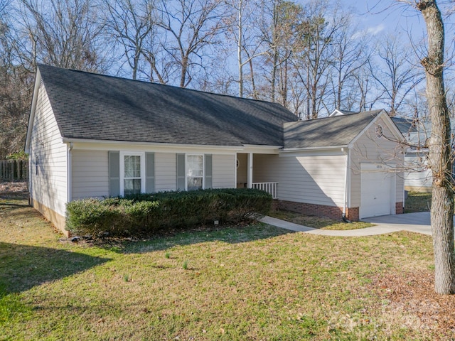 ranch-style home featuring a garage and a front lawn