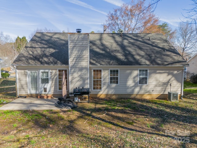 back of property with a yard, a patio area, and central air condition unit