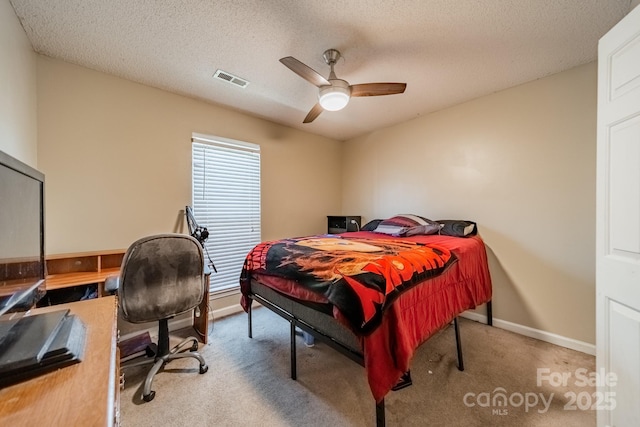 bedroom featuring ceiling fan, carpet, and a textured ceiling