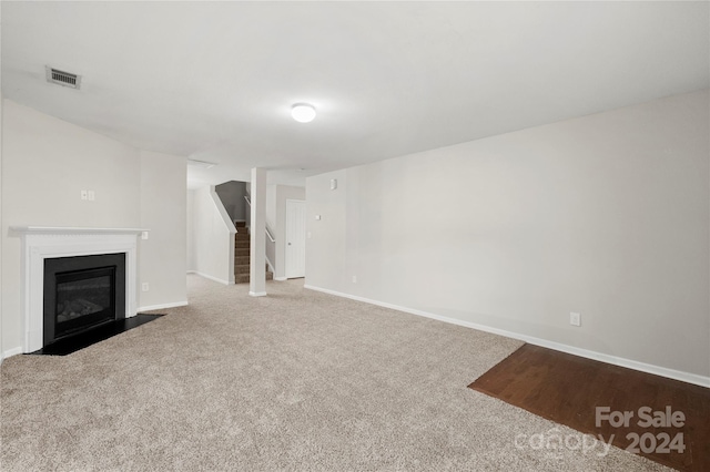 unfurnished living room with carpet flooring