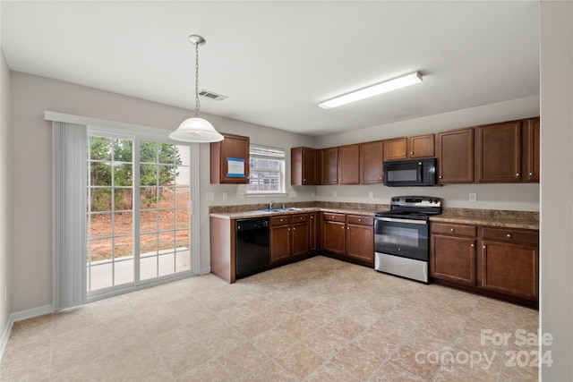 kitchen with hanging light fixtures, black appliances, and sink