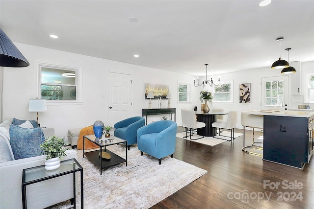 living room featuring dark hardwood / wood-style flooring and a notable chandelier