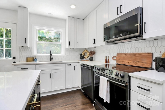 kitchen featuring white cabinets, stainless steel appliances, a wealth of natural light, and sink