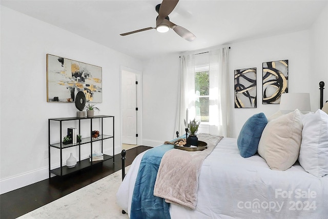 bedroom featuring ceiling fan and dark wood-type flooring