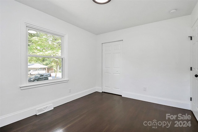 unfurnished room featuring dark hardwood / wood-style floors