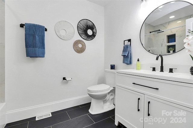 bathroom featuring a shower, tile patterned flooring, vanity, and toilet