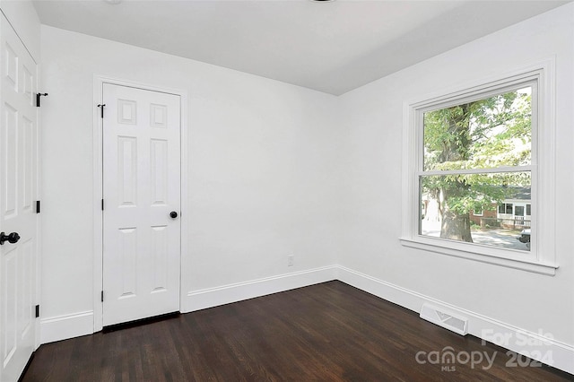 empty room featuring dark hardwood / wood-style flooring