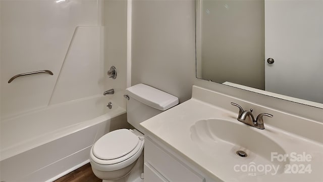 full bathroom featuring toilet, hardwood / wood-style floors, vanity, and washtub / shower combination