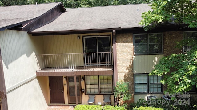 rear view of property with a balcony