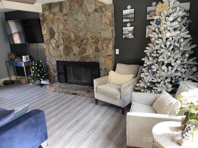 living room with hardwood / wood-style flooring and a fireplace