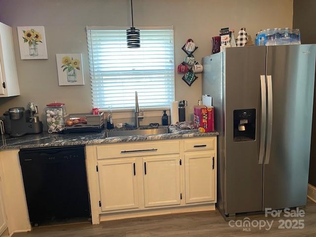 kitchen featuring sink, white cabinetry, dark hardwood / wood-style flooring, stainless steel fridge, and black dishwasher