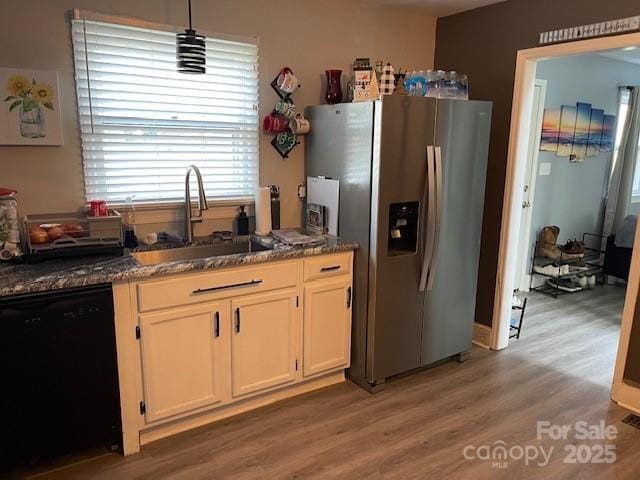 kitchen featuring sink, white cabinetry, wood-type flooring, stainless steel fridge with ice dispenser, and black dishwasher