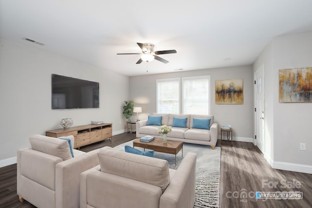 living room with ceiling fan and dark wood-type flooring