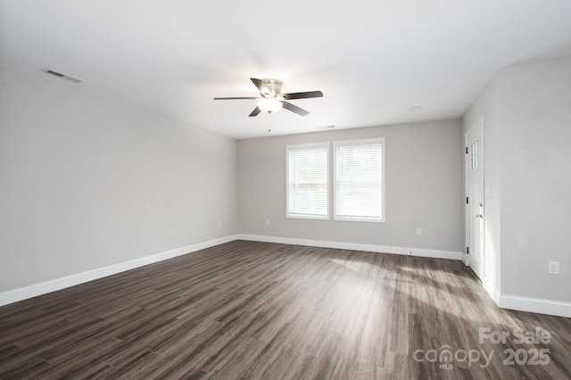 unfurnished room with ceiling fan and dark wood-type flooring