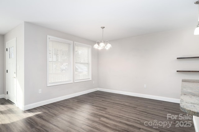 unfurnished dining area with a notable chandelier and dark hardwood / wood-style flooring