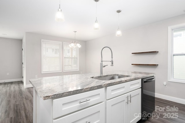 kitchen featuring dishwasher, white cabinets, sink, hanging light fixtures, and light stone countertops