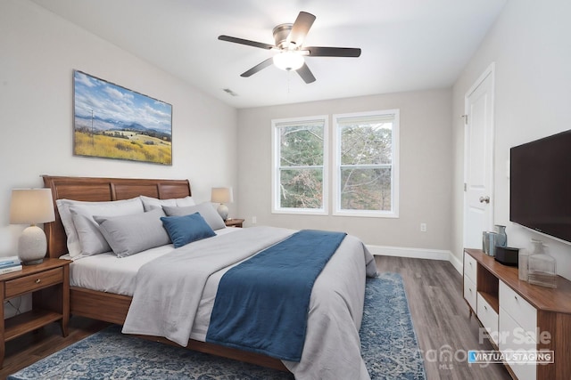 bedroom featuring dark hardwood / wood-style flooring and ceiling fan