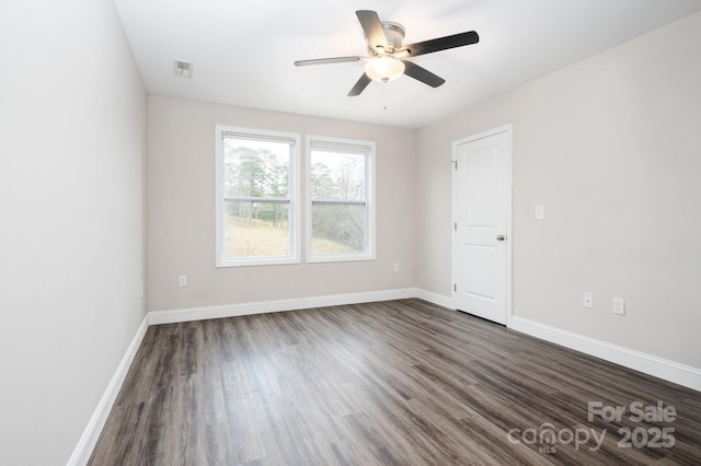 unfurnished room with dark hardwood / wood-style floors and ceiling fan