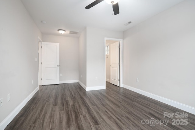 unfurnished bedroom with ceiling fan and dark wood-type flooring